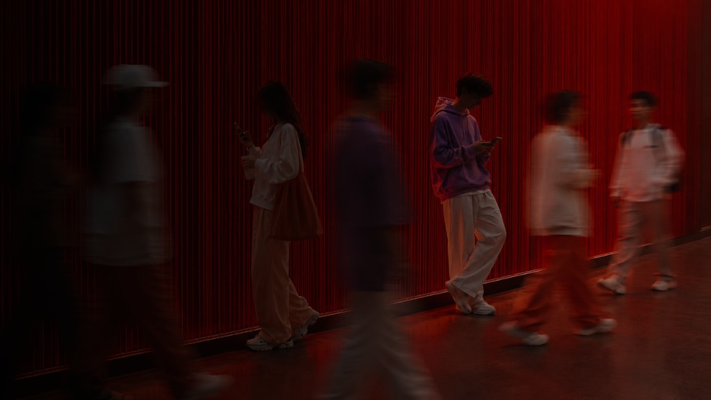 People in motion against a red-lit urban backdrop